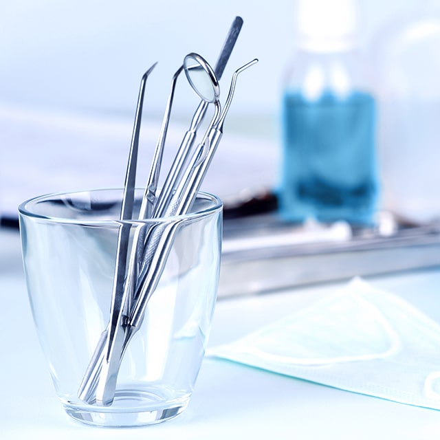 Clear cup with dentist tools